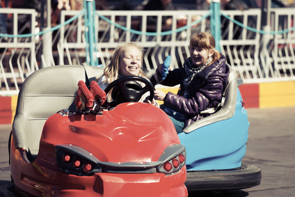 Happy teenage girls driving a bumper cars